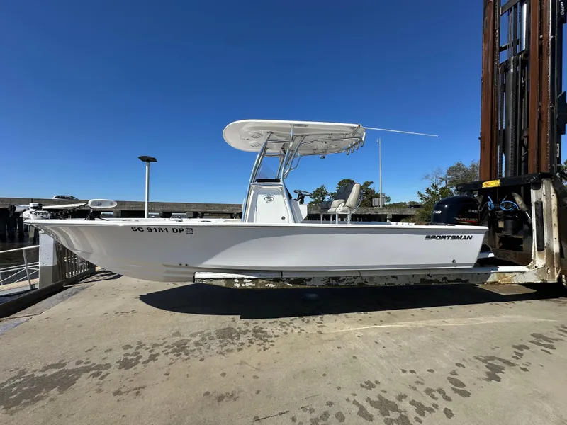 Slide: The Image of 2021 Sportsman Masters 247 Bay Boat on dock under clear blue sky. - 5