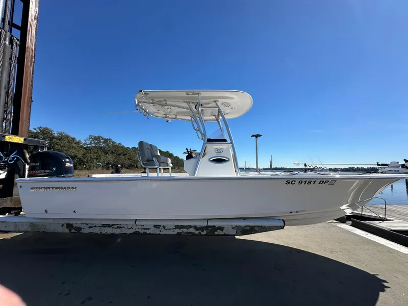 Slide: The Image of 2021 Sportsman Masters 247 Bay Boat docked under clear blue sky. - 7
