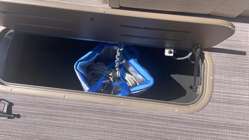 Slide: The Image of Open storage compartment in 2022 Veranda Relax VR22RC with blue bag inside. - 14