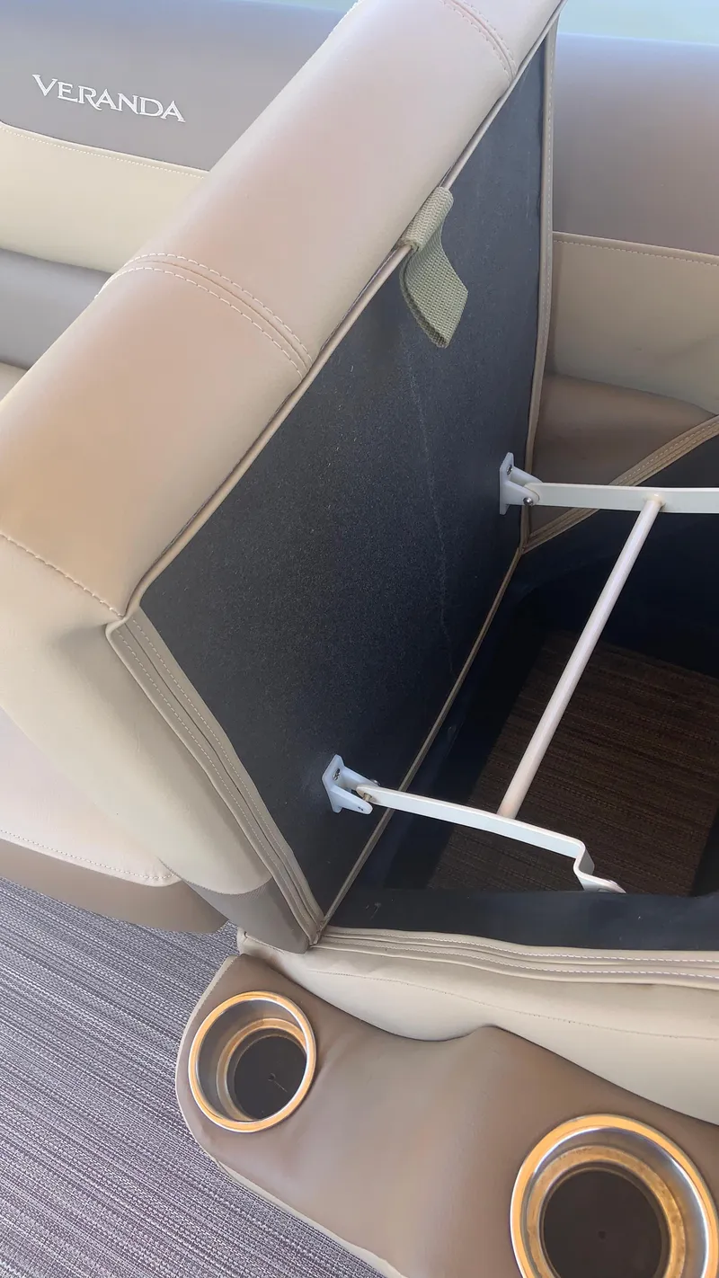 Slide: The Image of 2022 Veranda Relax VR22RC boat seat storage with cup holders and beige upholstery. - 16