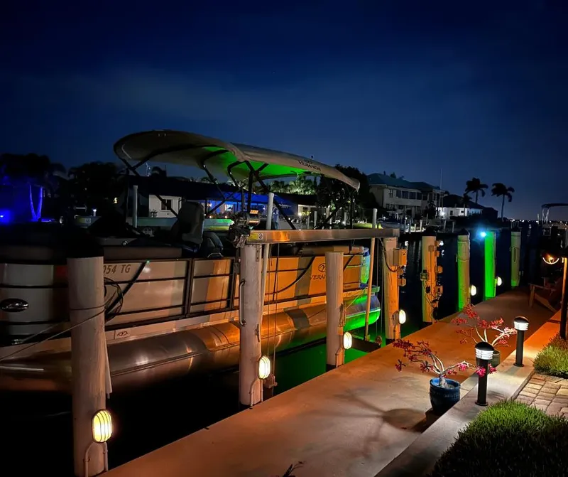 Slide: The Image of 2022 Veranda Relax VR22RC pontoon boat docked at night with ambient lighting. - 5