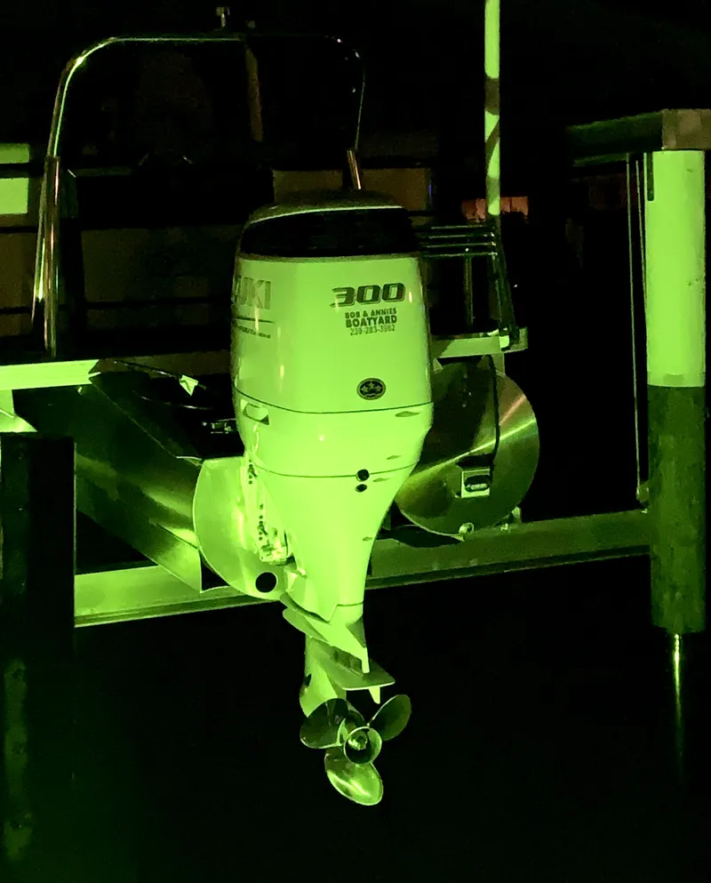 Slide: The Image of 2022 Veranda Relax VR22RC boat with 300 horsepower motor, illuminated in green light. - 6