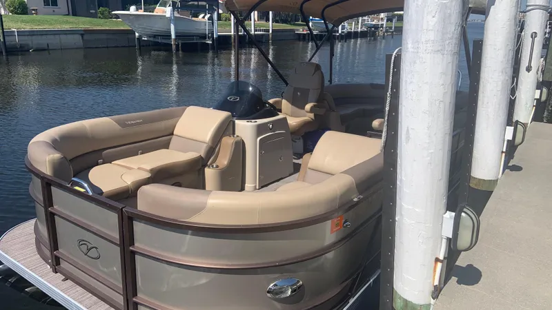 Slide: The Image of 2022 Veranda Relax VR22RC pontoon boat docked by the water. - 8