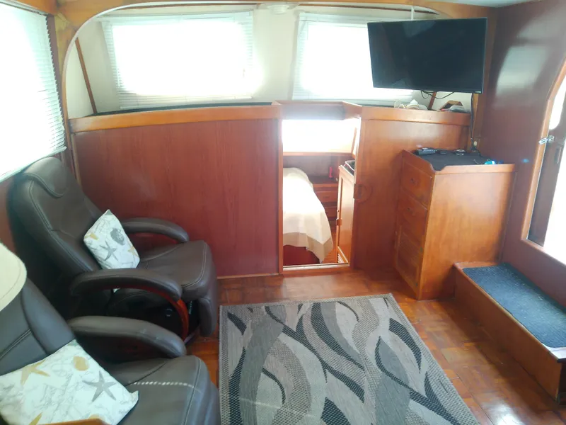 Slide: The Image of Interior of 1987 Albin 40 boat with seating, TV, and cozy decor. - 18