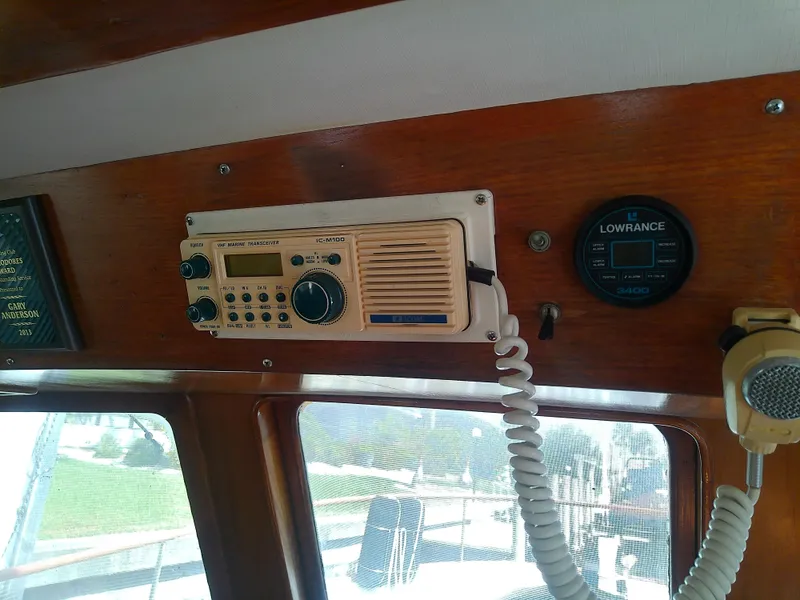 Slide: The Image of 1987 Albin 40 boat interior with vintage radio and Lowrance equipment. - 28