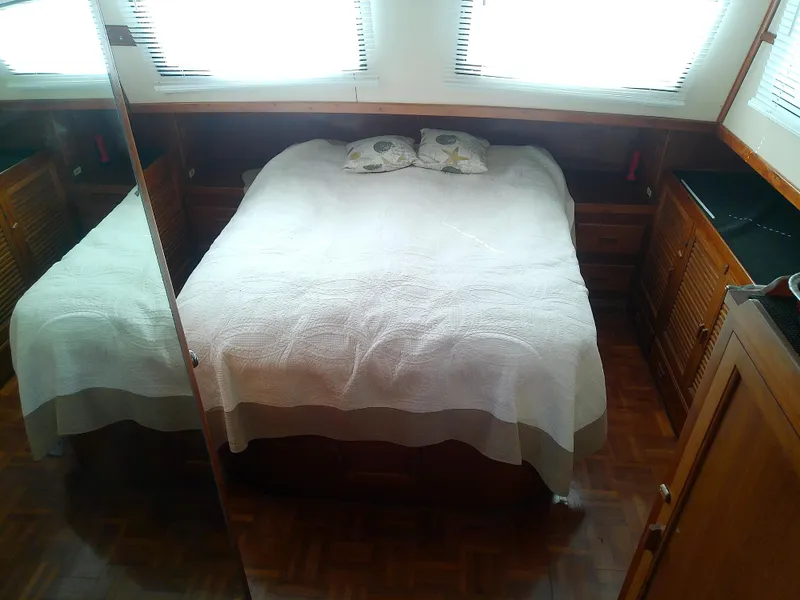 Slide: The Image of Cozy bedroom interior of 1987 Albin 40 boat with wooden furnishings and a double bed. - 30
