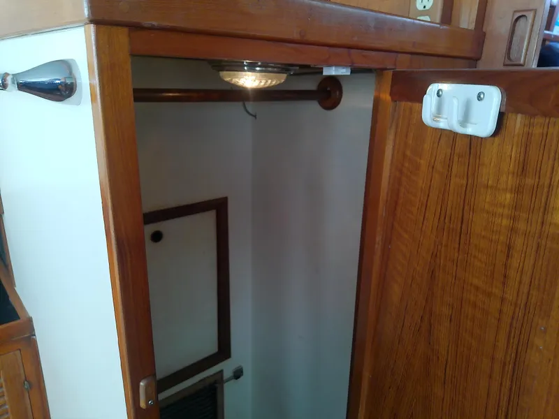 Slide: The Image of Wooden interior closet on a 1987 Albin 40 boat, featuring a light fixture. - 33