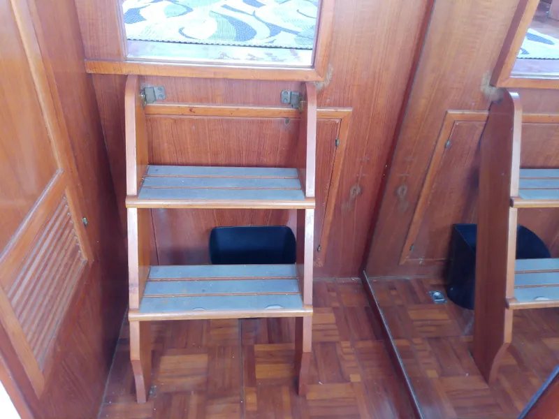 Slide: The Image of Wooden interior steps on 1987 Albin 40 boat, featuring parquet flooring and wooden paneling. - 37