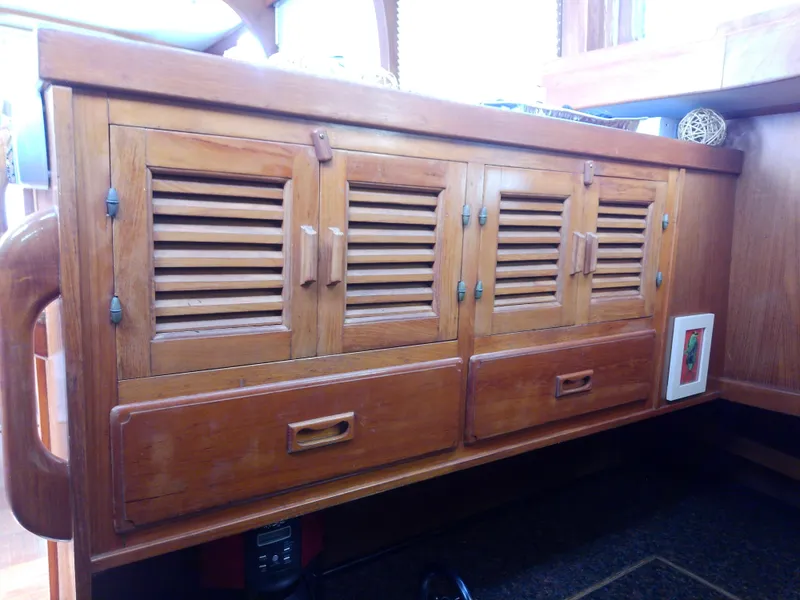 Slide: The Image of 1987 Albin 40 interior wooden cabinets with louvered doors and drawers. - 39