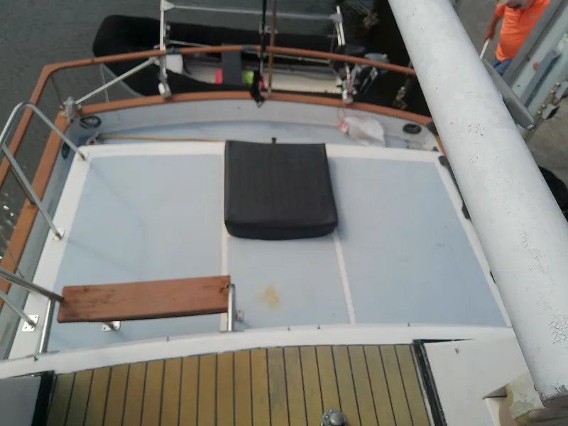 Slide: The Image of 1987 Albin 40 boat deck with wooden railings and seating area. - 47