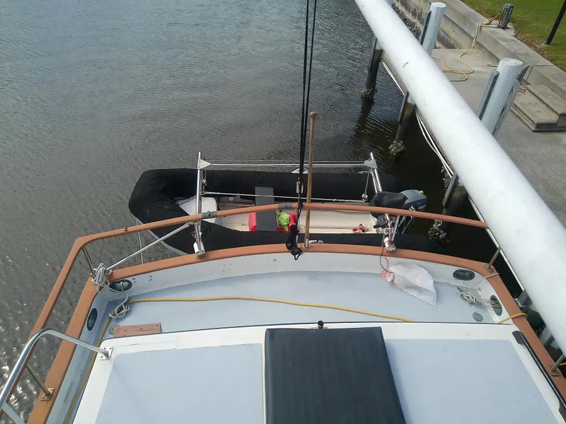 Slide: The Image of 1987 Albin 40 boat docked, view from deck, with inflatable dinghy nearby. - 49