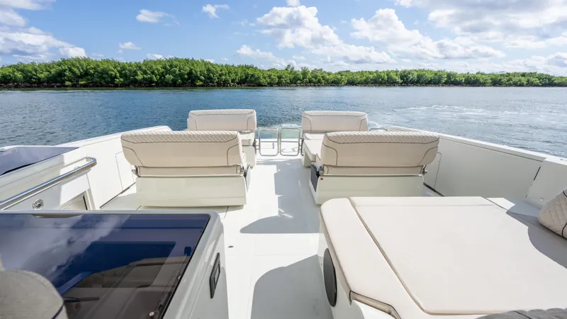 Slide: The Image of Luxurious Catana YOT 41 yacht deck with seating, overlooking serene water and lush greenery. - 7
