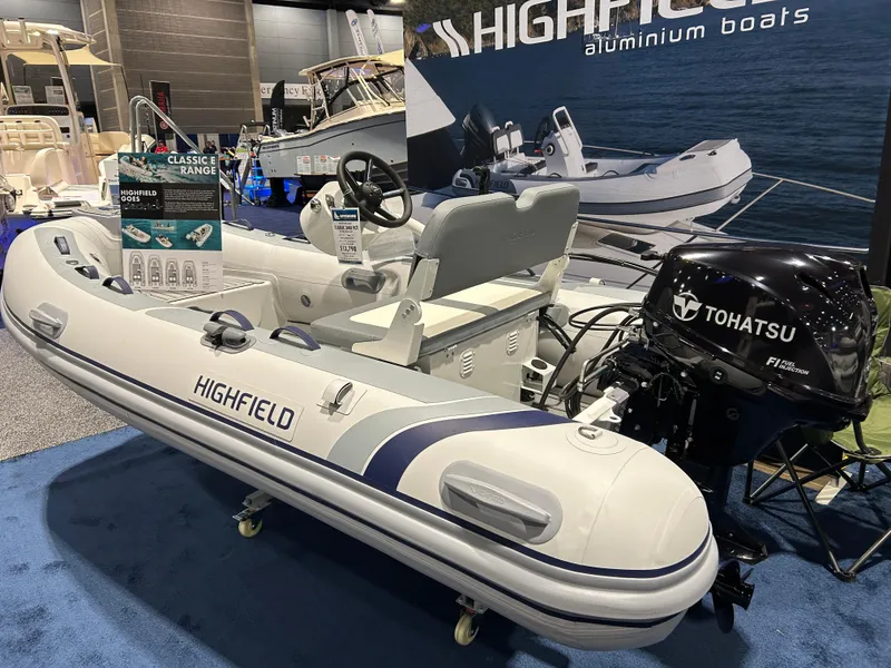 The Image of 2025 Highfield Classic 340 FCT inflatable boat with Tohatsu engine on display. - 0