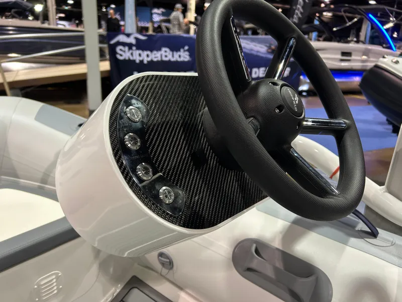 Slide: The Image of Steering console of 2025 Highfield Classic 340 FCT boat with carbon fiber finish. - 2