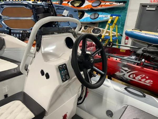 Slide: The Image of 2023 Highfield Sport 330 boat interior with steering wheel and control panel. - 8