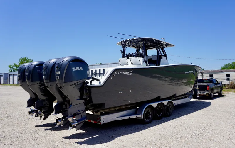Slide: The Image of 2020 Freeman 37 VH boat with triple Yamaha engines on a trailer. - 10