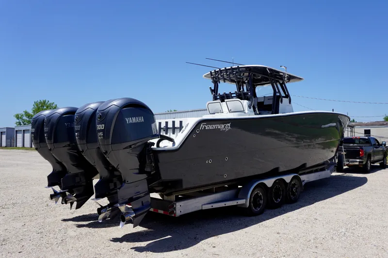 Slide: The Image of 2020 Freeman 37 VH boat with triple Yamaha engines on a trailer. - 11