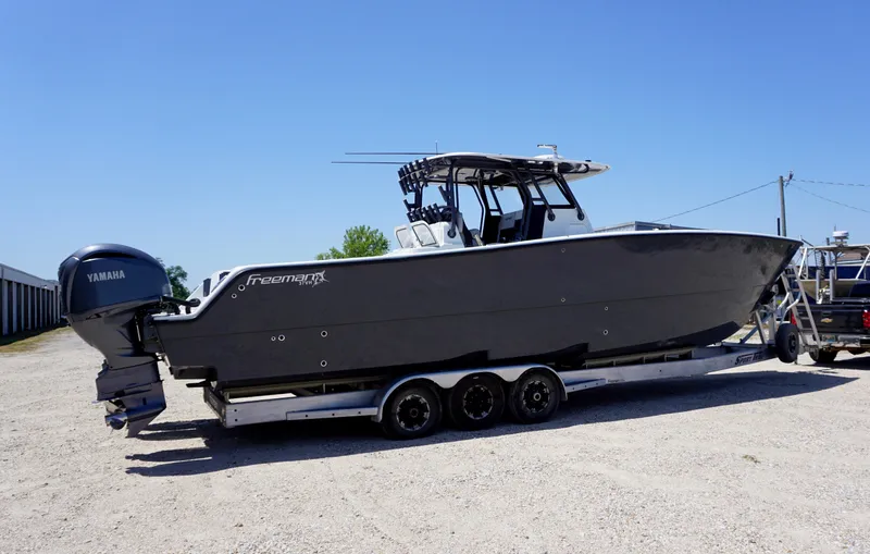 Slide: The Image of 2020 Freeman 37 VH boat on trailer with Yamaha engine, parked outdoors. - 12