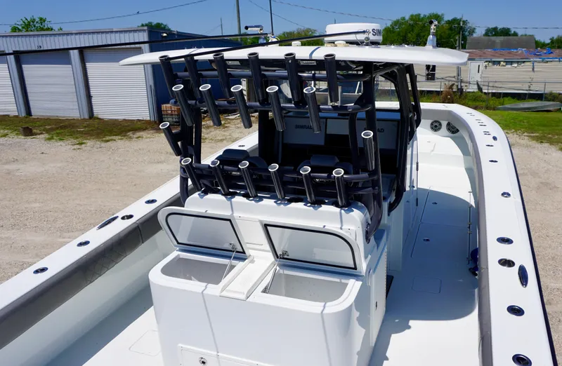 Slide: The Image of 2020 Freeman 37 VH boat with rod holders and spacious deck, parked outdoors. - 27