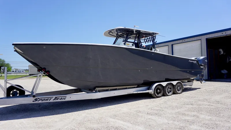 Slide: The Image of 2020 Freeman 37 VH boat on trailer outside a warehouse. - 3