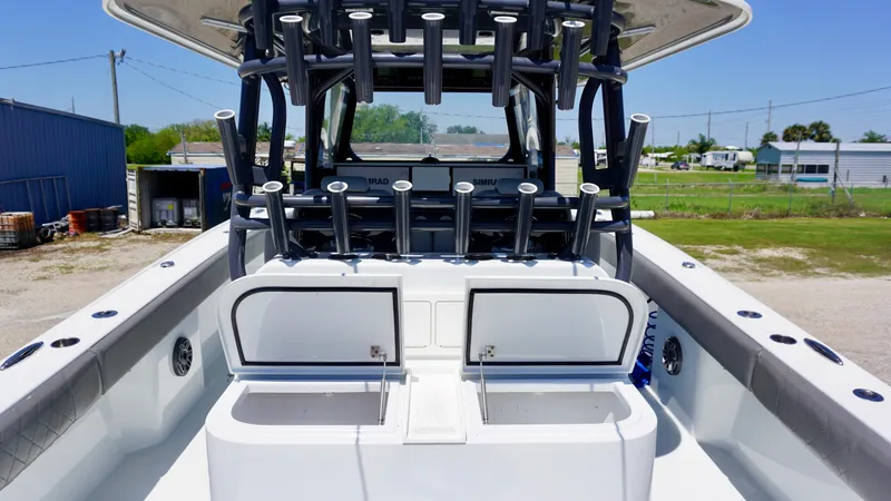 Slide: The Image of 2020 Freeman 37 VH boat with rod holders and storage compartments, docked outdoors. - 30