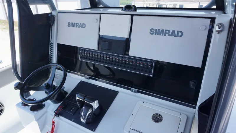 Slide: The Image of 2020 Freeman 37 VH boat dashboard with Simrad navigation system and steering wheel. - 39