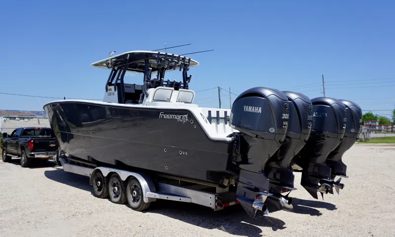 Slide: The Image of 2020 Freeman 37 VH boat with triple Yamaha engines on a trailer. - 7