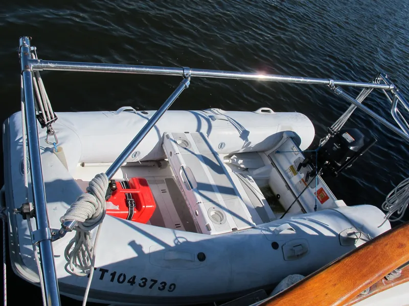 Slide: The Image of Inflatable dinghy secured on a Monk 36 boat, 1986 model, with visible motor and equipment. - 16