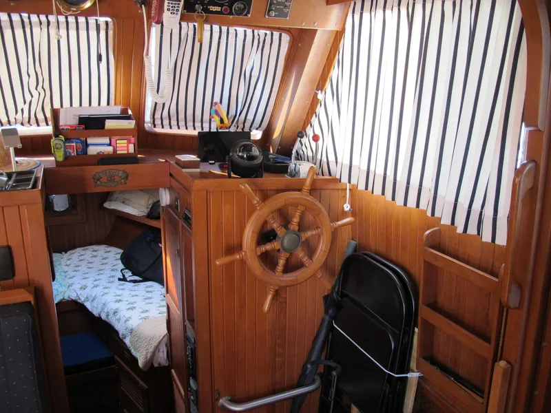 Slide: The Image of Interior of a 1986 Monk 36 boat with wooden paneling and nautical decor. - 18