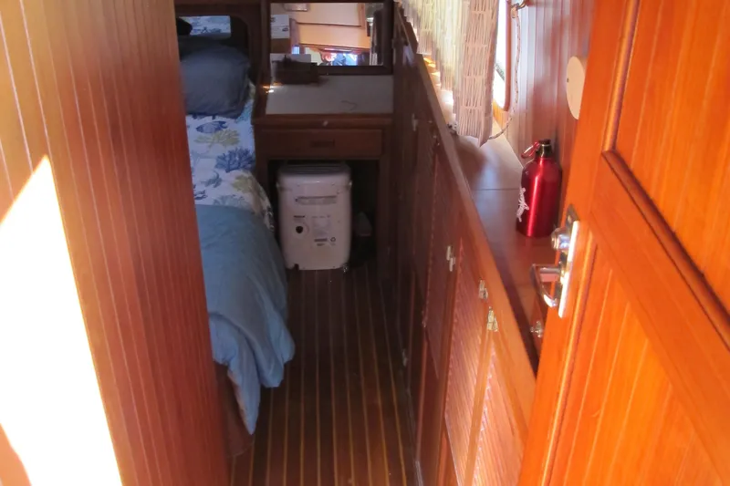 Slide: The Image of Interior of 1986 Monk 36 boat with wooden paneling and cozy cabin space. - 30