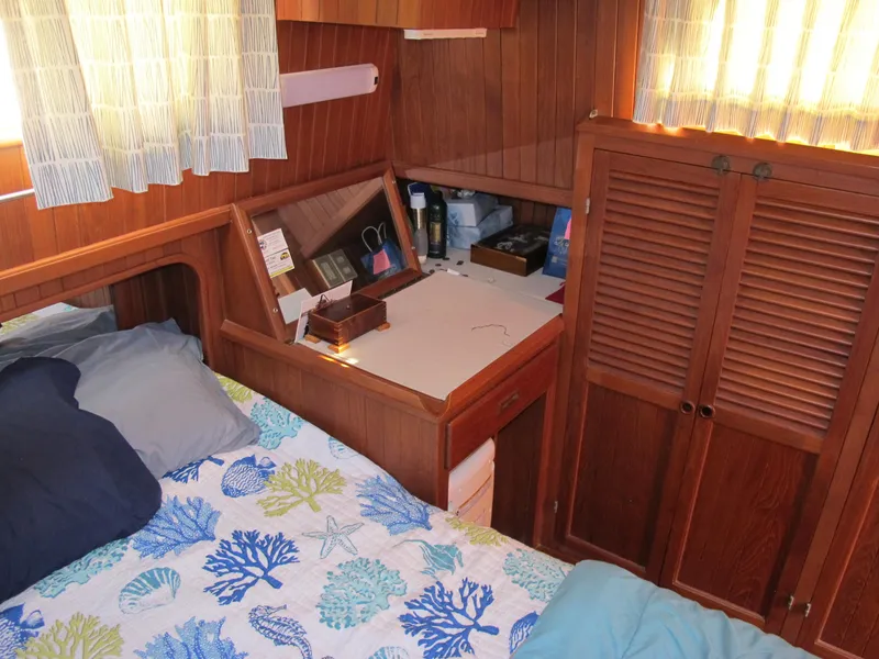 Slide: The Image of Cozy cabin interior of 1986 Monk 36 boat with wooden furnishings and nautical bedding. - 33