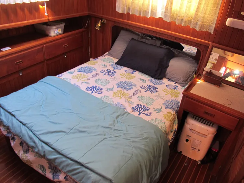 Slide: The Image of Cozy cabin bedroom in 1986 Monk 36 boat with floral bedding and wooden furnishings. - 34