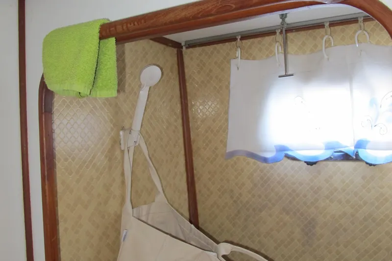 Slide: The Image of Interior of a 1986 Monk 36 boat with towel and curtain details. - 38