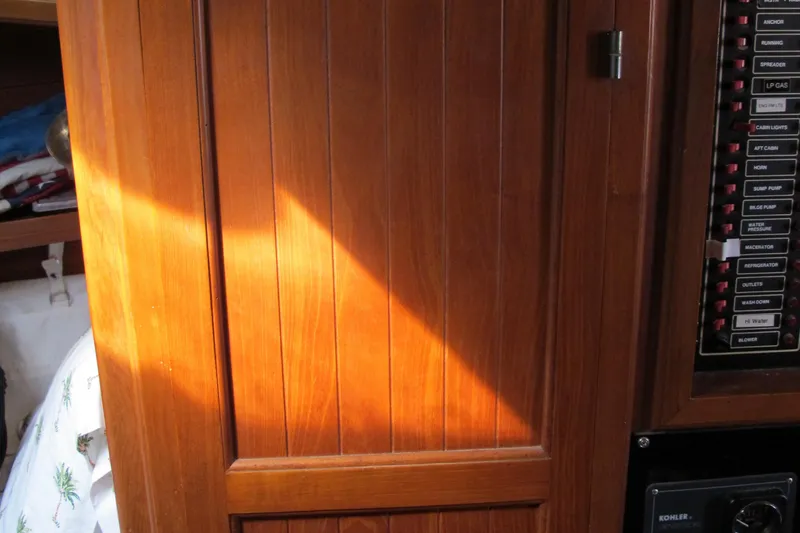 Slide: The Image of Wooden panel interior of a 1986 Monk 36 boat with control switches. - 41