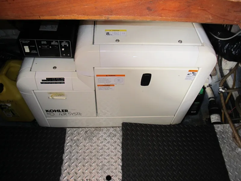 Slide: The Image of Kohler generator in a 1986 Monk 36 boat engine room, with metal flooring. - 46