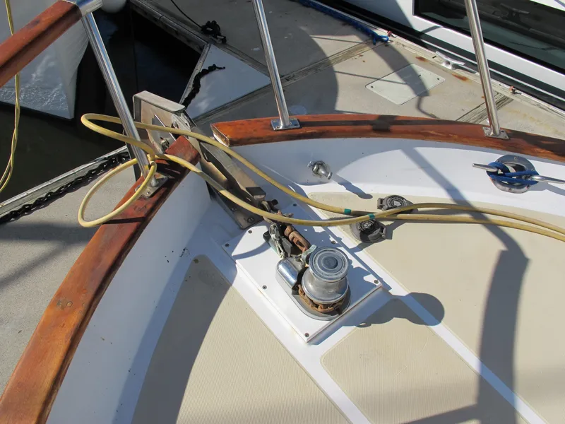 Slide: The Image of Deck of 1986 Monk 36 boat with winch and wooden railings. - 6