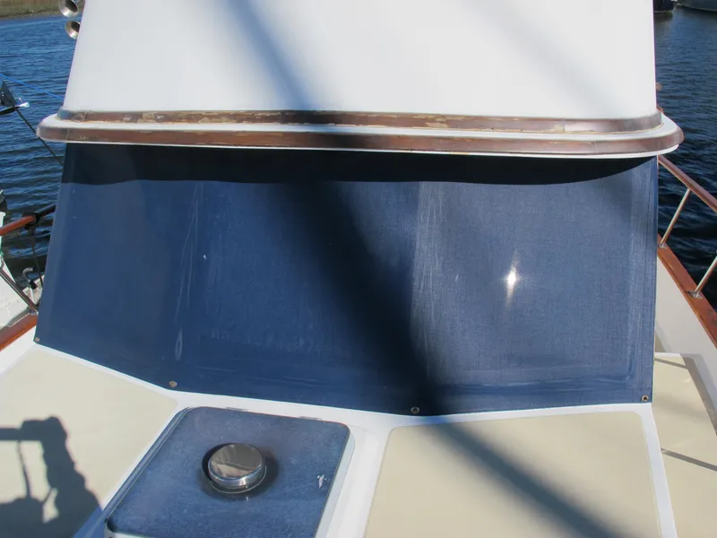 Slide: The Image of 1986 Monk 36 boat deck with blue canvas and metal fittings. - 9