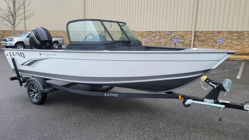 Slide: The Image of 2023 Lund 1775 Adventure Sport boat on trailer in parking lot. - 7