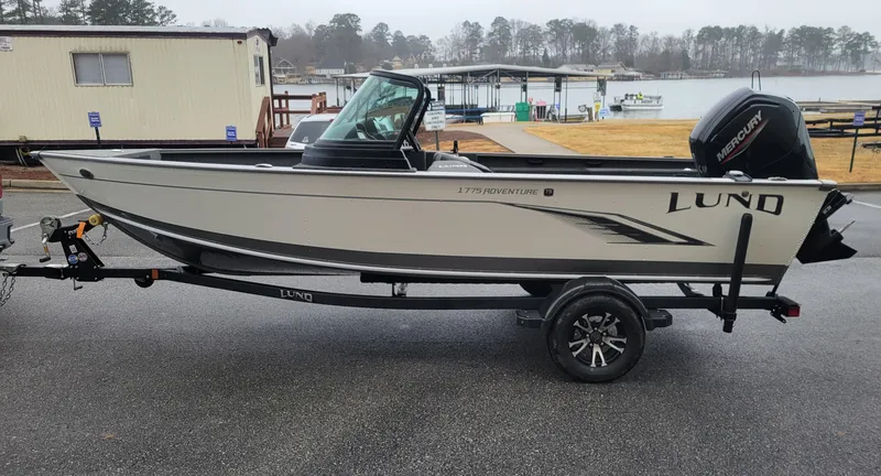 Slide: The Image of 2023 Lund 1775 Adventure Sport boat on trailer by a lakeside. - 8