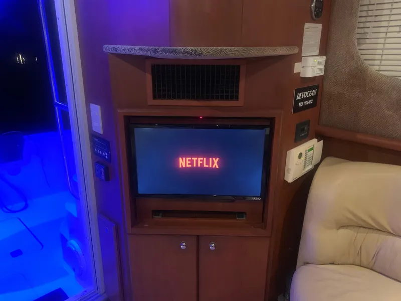 Slide: The Image of Interior of 2006 Silverton 34 Convertible yacht with Netflix on TV screen. - 14