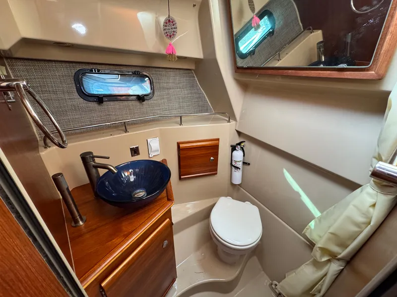 Slide: The Image of 2019 Ranger Tugs R-27 bathroom with modern sink, toilet, and window. - 10