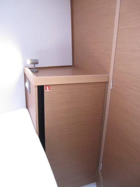 Slide: The Image of 2025 Jeanneau Sun Odyssey 350 interior, featuring sleek wooden cabinetry design. - 27