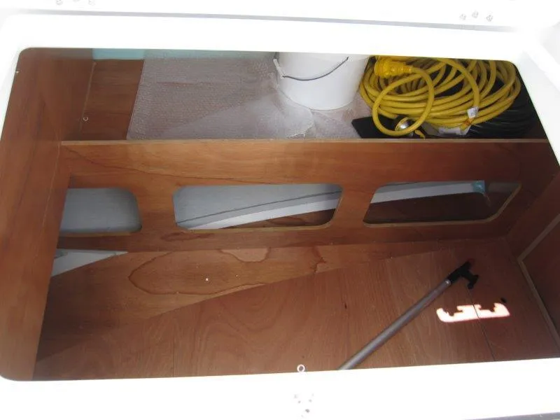 Slide: The Image of Storage compartment of 2025 Jeanneau Sun Odyssey 350 with hose and equipment. - 49