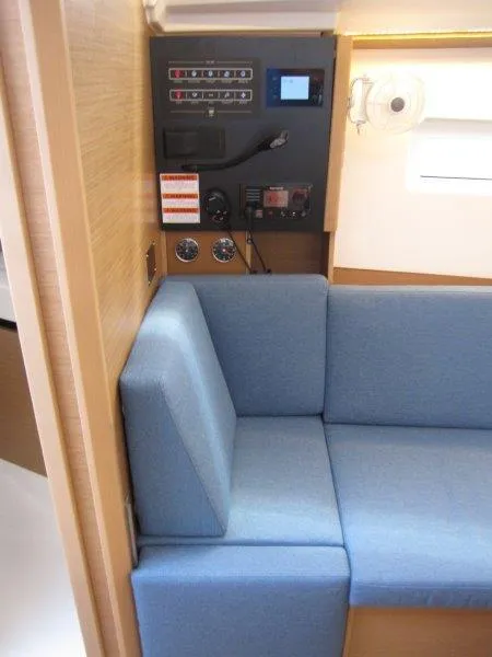 Slide: The Image of Interior of 2025 Jeanneau Sun Odyssey 350 yacht with blue seating and control panel. - 5
