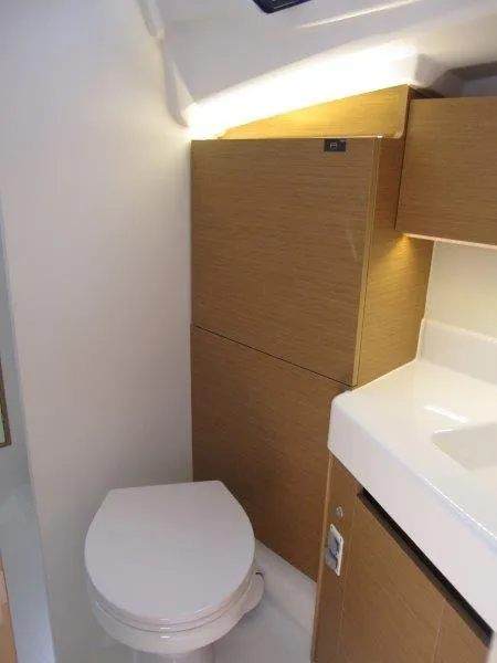 Slide: The Image of 2025 Jeanneau Sun Odyssey 350 yacht bathroom with modern fixtures and wooden cabinetry. - 15