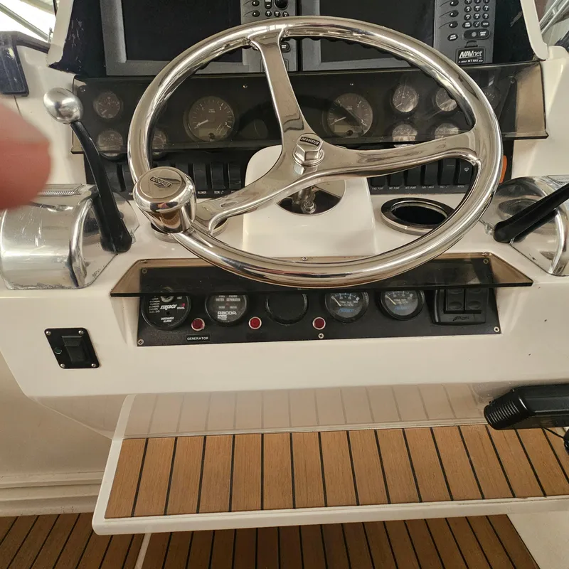 Slide: The Image of 1994 Blackfin 33 Combi boat helm with steering wheel and control panel. - 10