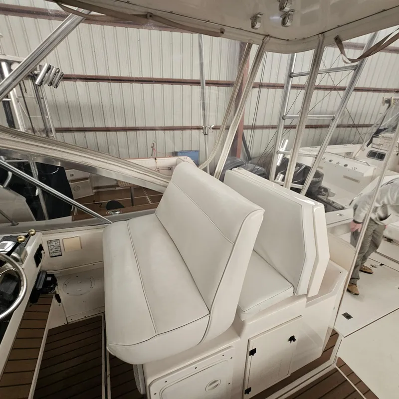 Slide: The Image of 1994 Blackfin 33 Combi boat interior with white seating and steering area. - 14