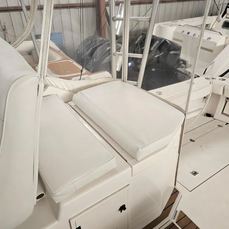 Slide: The Image of 1994 Blackfin 33 Combi boat interior with white seating and visible outboard motors. - 15