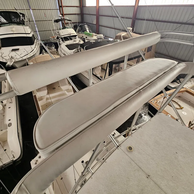 Slide: The Image of 1994 Blackfin 33 Combi boat in storage, featuring a cushioned seating area. - 21