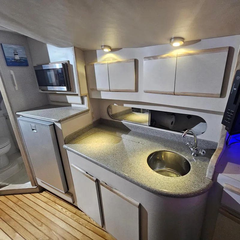 Slide: The Image of 1994 Blackfin 33 Combi boat interior kitchen with sink, cabinets, and appliances. - 27